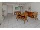 Open dining room with tile floors, a wooden dining table and chairs under a chandelier light at 232 Cerromar Way # 38, Venice, FL 34293