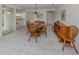 Open dining room with tile floors, a wooden dining table and chairs under a chandelier light at 232 Cerromar Way # 38, Venice, FL 34293