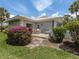 Rear exterior of the house with a patio, garden, and lawn at 232 Cerromar Way # 38, Venice, FL 34293