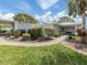 Beautiful home exterior featuring manicured landscaping, a walkway, and a cozy bench, offering a welcoming entrance at 232 Cerromar Way # 38, Venice, FL 34293