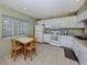 Eat-in kitchen with a table and chairs, white appliances and a view of the yard at 232 Cerromar Way # 38, Venice, FL 34293