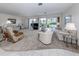 Spacious living room with neutral carpet, sliding glass doors, and ample seating, ideal for entertaining guests at 232 Cerromar Way # 38, Venice, FL 34293