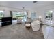 Bright living room featuring a large sliding glass door, neutral tones, and comfortable seating, creating a cozy atmosphere at 232 Cerromar Way # 38, Venice, FL 34293