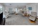 Expansive living space with neutral tones, ample seating, and natural light, seamlessly connecting living and dining areas at 232 Cerromar Way # 38, Venice, FL 34293