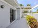 Patio with white pergola, lush landscaping, and peaceful vibe at 232 Cerromar Way # 38, Venice, FL 34293