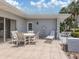 Tiled back patio with seating area surrounded by landscaping at 232 Cerromar Way # 38, Venice, FL 34293