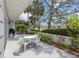 Back patio area with outdoor dining set and greenery at 232 Cerromar Way # 38, Venice, FL 34293