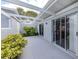 Covered patio with sliding glass doors and well-maintained landscaping at 232 Cerromar Way # 38, Venice, FL 34293