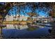 Beautiful community buildings reflected in a serene pond with lush landscaping and mature trees at 232 Cerromar Way # 38, Venice, FL 34293