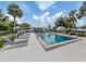 Sparkling pool surrounded by lounge chairs and lush landscaping in a well-maintained community at 232 Cerromar Way # 38, Venice, FL 34293