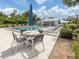 Poolside view with tables, chairs, lounges, and a shelter, perfect for enjoying warm, sunny weather at 232 Cerromar Way # 38, Venice, FL 34293