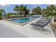 Community pool with lounge chairs and clear water, ideal for swimming and sunbathing at 232 Cerromar Way # 38, Venice, FL 34293