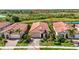 An aerial view showcases this charming single-story house with a lush backyard overlooking a serene pond at 23493 Copperleaf Dr, Venice, FL 34293