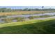 Lush backyard overlooking a pond, offering a private and peaceful outdoor space at 23493 Copperleaf Dr, Venice, FL 34293