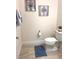 Cozy bathroom featuring tiled floor, neutral walls, and charming decorative wall art at 23493 Copperleaf Dr, Venice, FL 34293