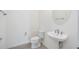 Bright bathroom featuring a toilet, floating sink, and large mirror, offering a clean space at 23493 Copperleaf Dr, Venice, FL 34293
