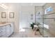 Modern bathroom featuring granite countertops, double sinks, and walk-in glass shower at 23493 Copperleaf Dr, Venice, FL 34293