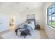 Calm bedroom featuring a comfortable bed, neutral decor, and views of the outdoor landscape at 23493 Copperleaf Dr, Venice, FL 34293