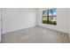 This room features tile floors and a window overlooking a well-maintained lawn with palm trees at 23493 Copperleaf Dr, Venice, FL 34293
