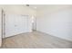 A bright bedroom with tiled floor, a sliding door closet, and white trim at 23493 Copperleaf Dr, Venice, FL 34293