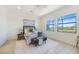 Serene bedroom featuring ample natural light, neutral decor, and views of the lush outdoor landscape at 23493 Copperleaf Dr, Venice, FL 34293
