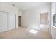 Sunny bedroom featuring neutral carpet, ample natural light, and access to an ensuite bathroom at 23493 Copperleaf Dr, Venice, FL 34293