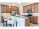 Charming kitchen with granite countertops, stainless steel appliances, and stylish bar seating at the kitchen island at 23493 Copperleaf Dr, Venice, FL 34293