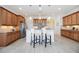 Charming kitchen features granite counters, wooden cabinets, a center island, and modern stainless steel appliances at 23493 Copperleaf Dr, Venice, FL 34293