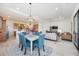Open-concept living and dining area with light tile flooring and seamless access to a kitchen space at 23493 Copperleaf Dr, Venice, FL 34293
