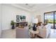 Cozy living room with tray ceilings, neutral decor, and a view of the backyard at 23493 Copperleaf Dr, Venice, FL 34293