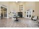 Spacious lobby featuring neutral decor, elegant light fixtures, tile flooring, and seating areas to welcome residents and guests at 23493 Copperleaf Dr, Venice, FL 34293