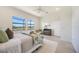 Bright main bedroom with neutral walls and floors, fan, and natural light at 23493 Copperleaf Dr, Venice, FL 34293