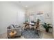 Cozy home office with a wood desk, comfortable chair, rug, and natural light from window at 23493 Copperleaf Dr, Venice, FL 34293