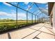 Spacious screened patio with beautiful brick flooring and picturesque views of the natural surroundings at 23493 Copperleaf Dr, Venice, FL 34293
