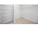 Walk-in closet with built-in metal shelving, maximizing storage space and organization at 23493 Copperleaf Dr, Venice, FL 34293