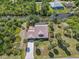 Aerial view of a home with a screened pool, and a waterfront lot at 236 Cory St, Port Charlotte, FL 33953