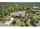 Aerial view of a home nestled among lush greenery, showcasing its serene and private setting at 236 Cory St, Port Charlotte, FL 33953