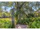 Landscaped backyard with a pergola and access to the canal at 236 Cory St, Port Charlotte, FL 33953