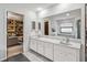 Bright bathroom featuring dual sinks, neutral tiling and glass shower at 236 Cory St, Port Charlotte, FL 33953