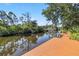 Backyard dock with views of the canal and mature trees at 236 Cory St, Port Charlotte, FL 33953
