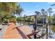 Waterfront home with a wooden dock and boat lift for enjoying the canal at 236 Cory St, Port Charlotte, FL 33953