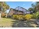 Beautiful home featuring a large screened-in lanai and mature landscaping at 236 Cory St, Port Charlotte, FL 33953