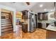 The kitchen offers stainless steel appliances, tiled floors, wine rack and seamless access to the staircase at 236 Cory St, Port Charlotte, FL 33953