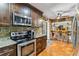 Well-equipped kitchen with stainless steel appliances and granite countertops overlooking a bar area at 236 Cory St, Port Charlotte, FL 33953