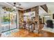 Open living room featuring a stone bar, terracotta tile floors, and view to the pool at 236 Cory St, Port Charlotte, FL 33953