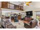 Spacious living room featuring vaulted ceilings, balcony, and a large entertainment center at 236 Cory St, Port Charlotte, FL 33953