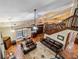 Spacious living room with two leather sofas, ceiling fan, staircase and a beautiful area rug at 236 Cory St, Port Charlotte, FL 33953