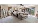 Comfortable main bedroom with four poster bed, sitting area, balcony access and neutral decor at 236 Cory St, Port Charlotte, FL 33953