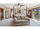 Relaxing main bedroom with sofa, four poster bed, balcony access and neutral decor at 236 Cory St, Port Charlotte, FL 33953
