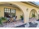 Inviting covered patio with arched entryways, cozy seating, and decorative plants at 236 Cory St, Port Charlotte, FL 33953